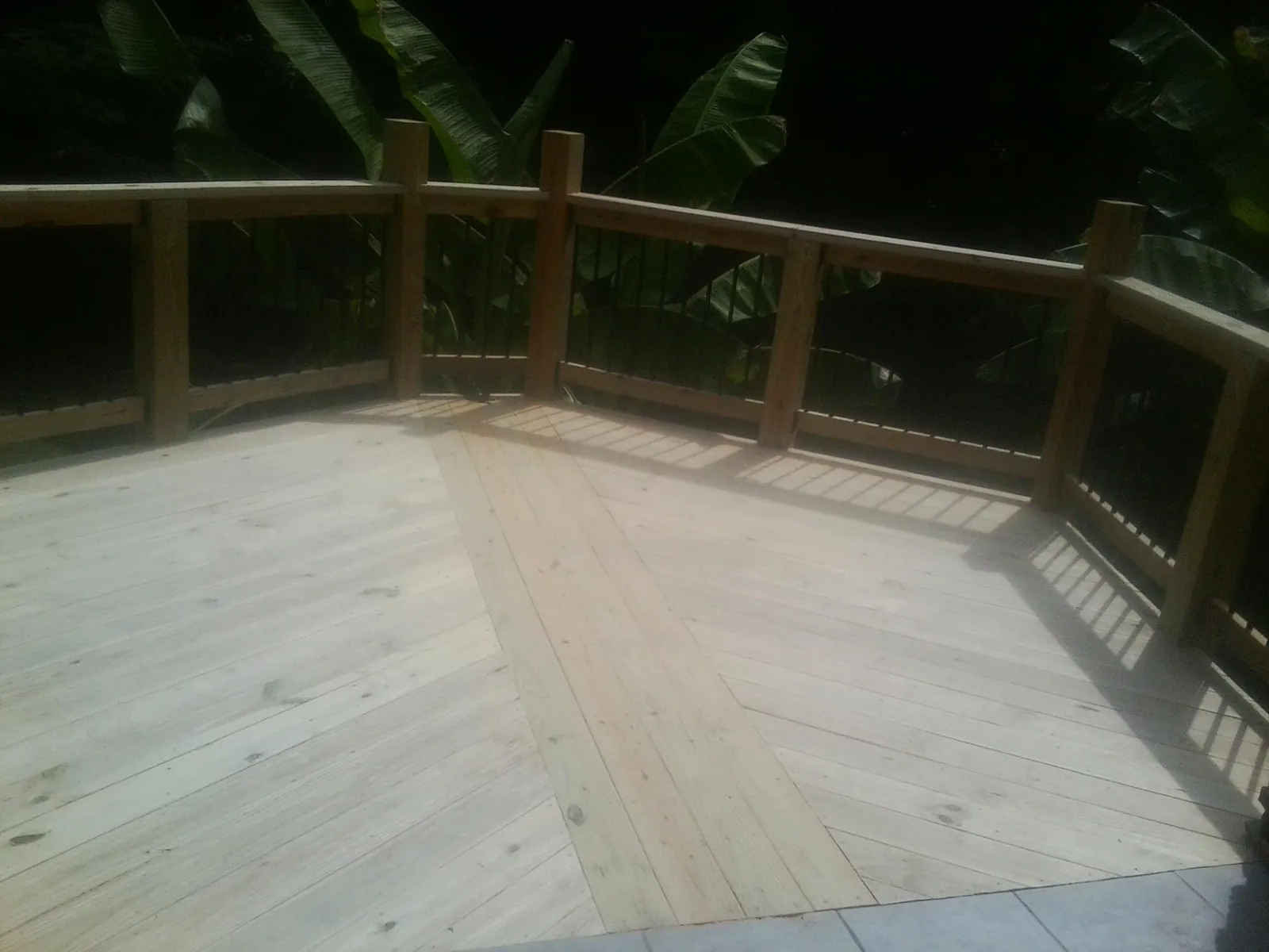 New wood deck and railing built off the back of a home in Poolesville
